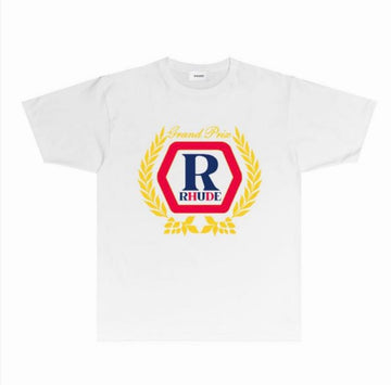 White t-shirt featuring bold “RHUDE” and “Grand Prix” text with navy, red, and yellow laurel graphic on front, classic short sleeve design.