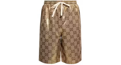 Gucci branded beige shorts featuring the iconic GG logo pattern, with a drawstring waist and side pockets.