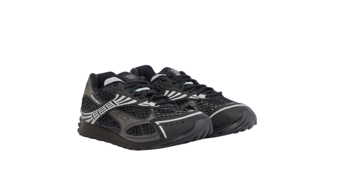 A pair of black and grey running sneakers with mesh detailing, sleek lines, and a low-profile design, perfect for athletic wear.