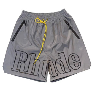 Gray Rhude brand shorts with a yellow drawstring and black zippered pockets, displayed against a white background.