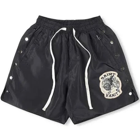 A pair of black Saint Laurent shorts with side snap buttons, an elastic waistband, and a patch logo on the front.
