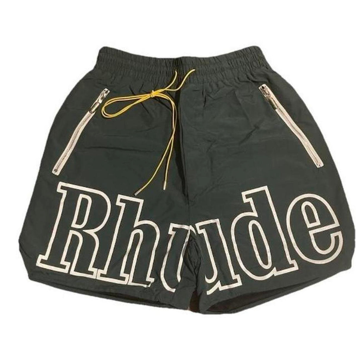 Black shorts with large white outlined "Rhude" text on the front, yellow drawstring, and white zipper pockets on each side.