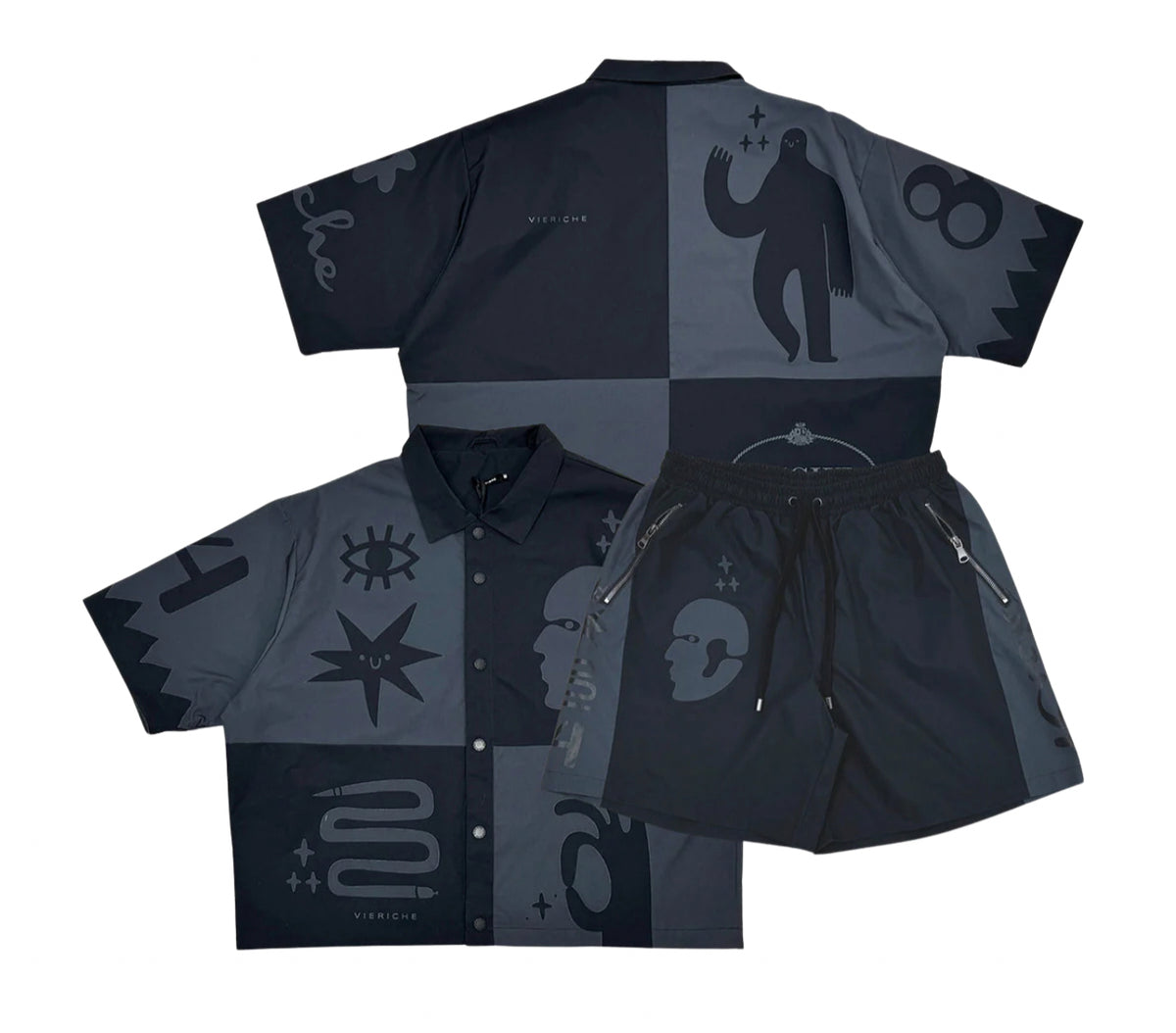 A black and grey patterned shirt and shorts set with various bold graphic designs like eyes, faces, and stars on the fabric.
