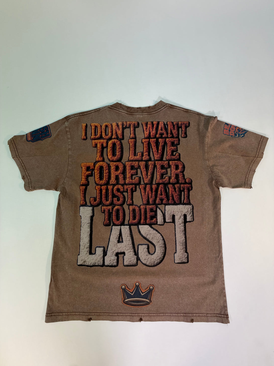 A vintage faded brown short-sleeve t-shirt with a distressed graphic reading 'KUSH CONN' and 'BEARDOWN' featuring a cartoon bear holding a coffee cup.